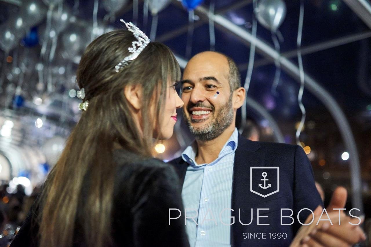 A woman and a man dancing on a decorated boat