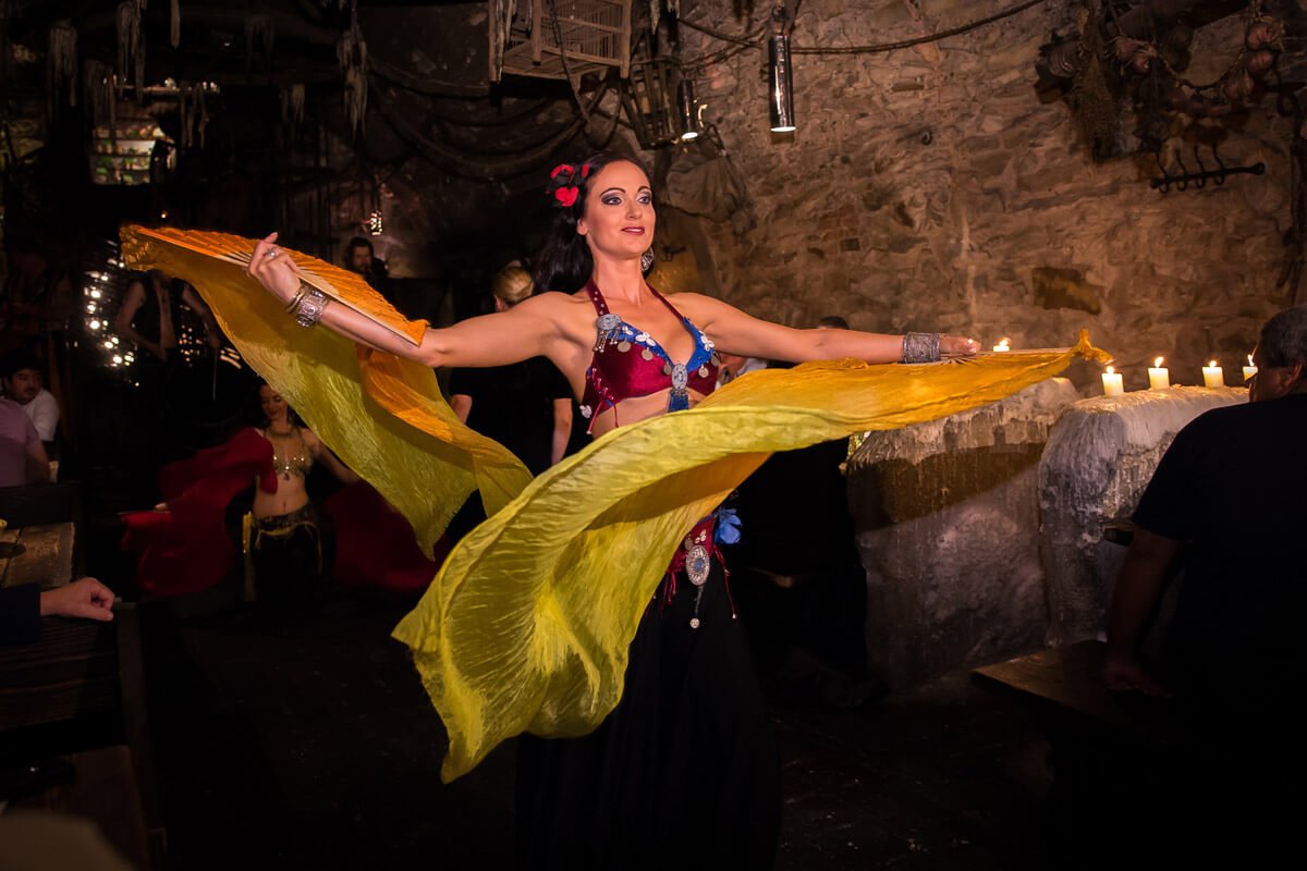 A woman holding a sheet and twirling it around herself
