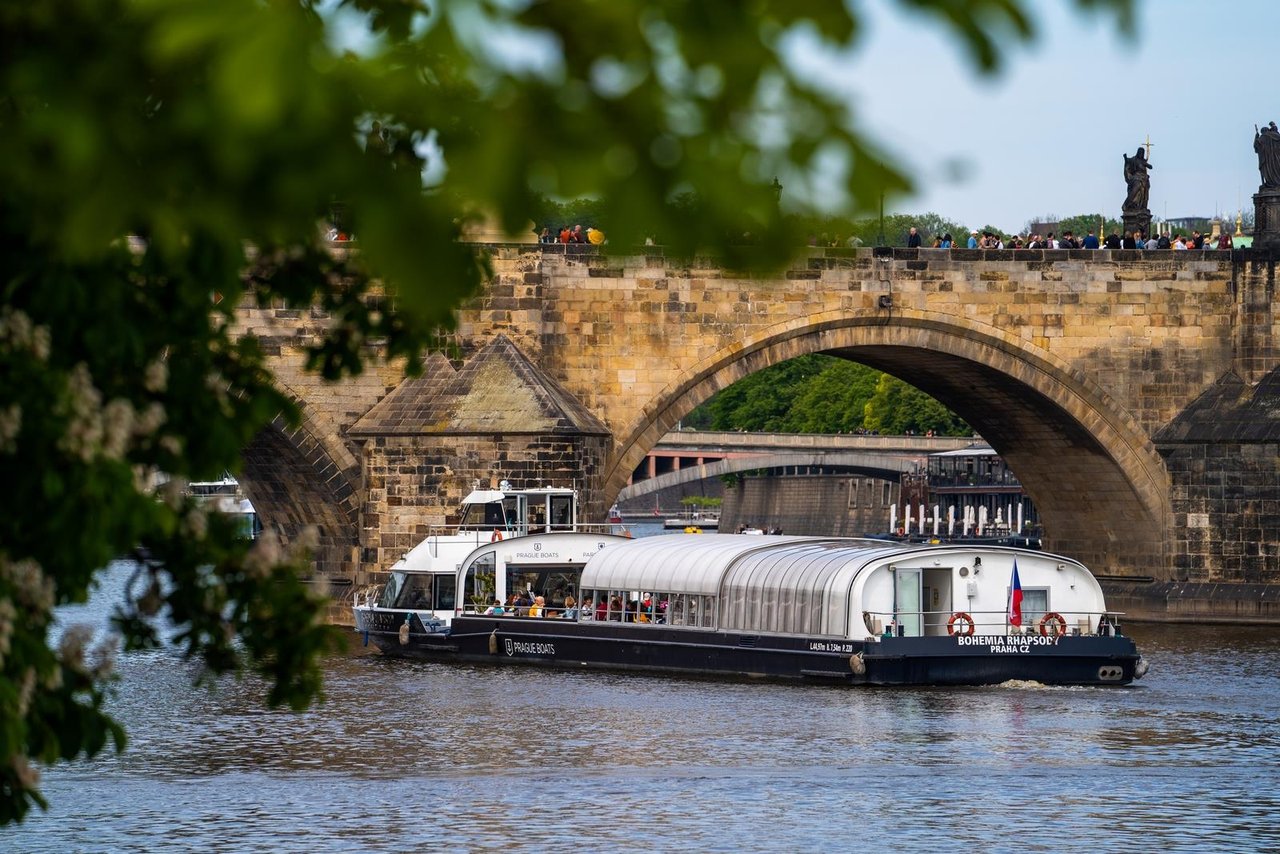 A tour boat about to pass under a bridge